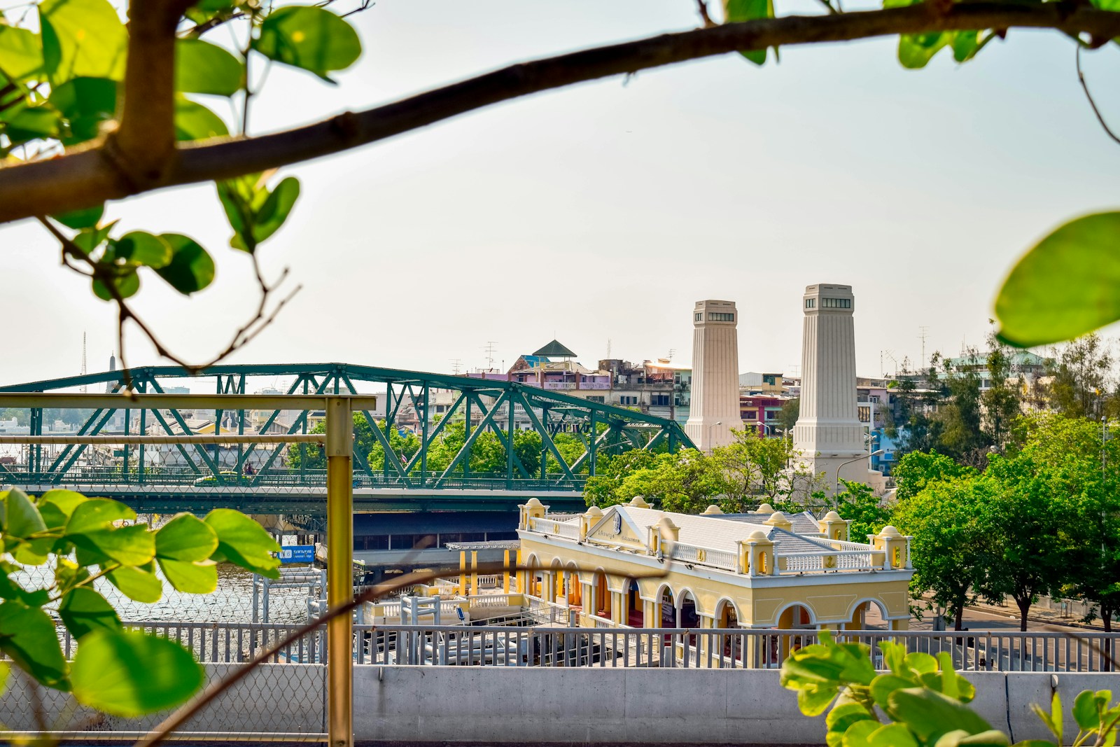 A bridge over a river with a city in the background